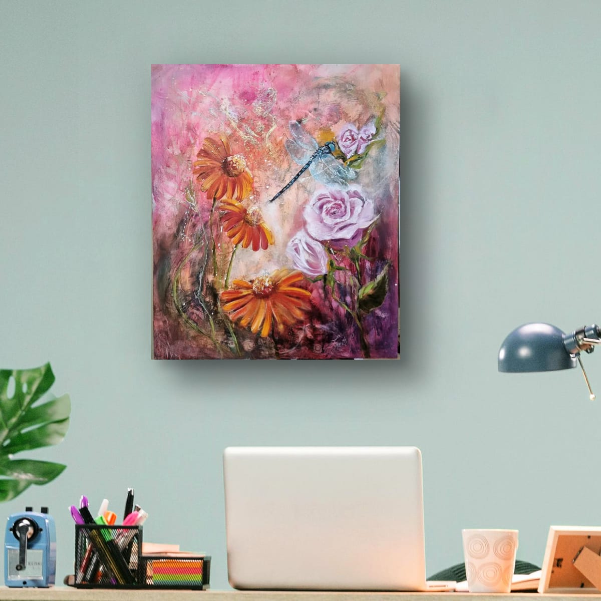 Blue dragonfly with shimmering wings surrounded by pink roses and floral textures in a soft, romantic mixed media painting symbolising transformation and intuition by Lynette Mary Skeers